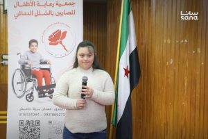 طفلة سورية من ذوي الشلل الدماغي في فاعلية بجامعة دمشق